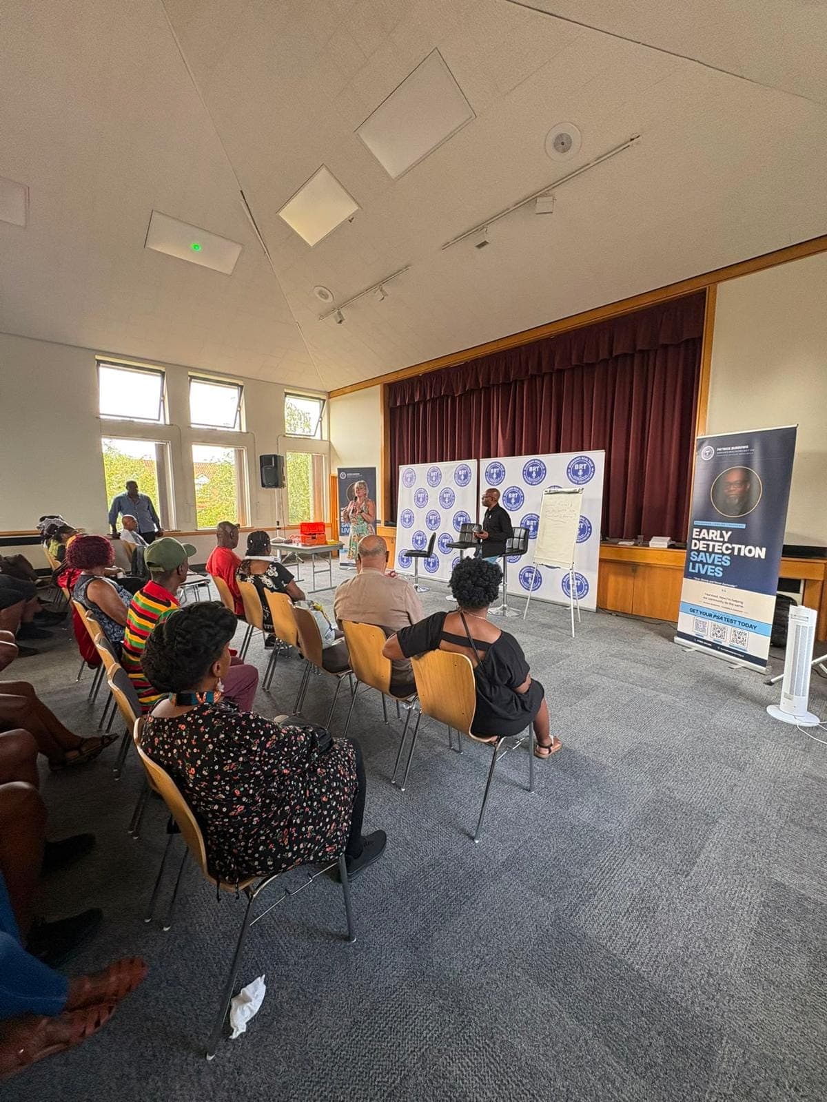 A wide view of the hall from the back left with the event banner on the right.